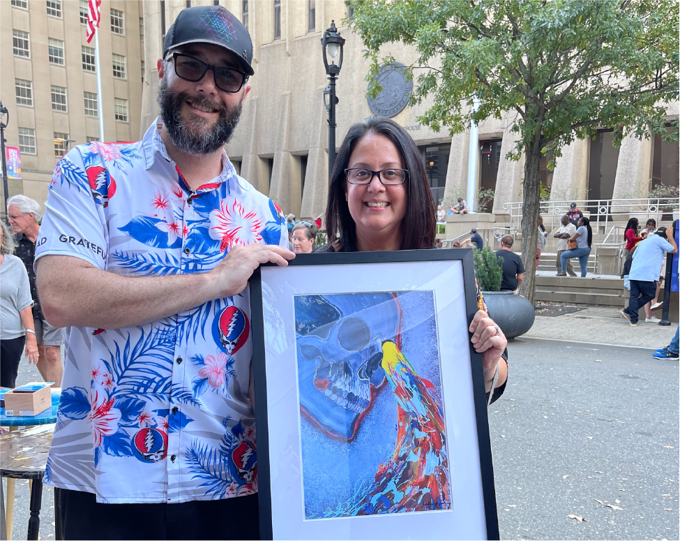 Customers holding framed canvas artwork