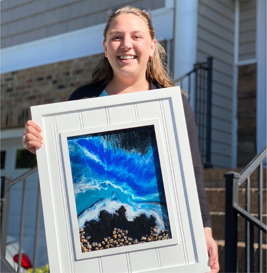 Customer holding her ocean-themed canvas art 