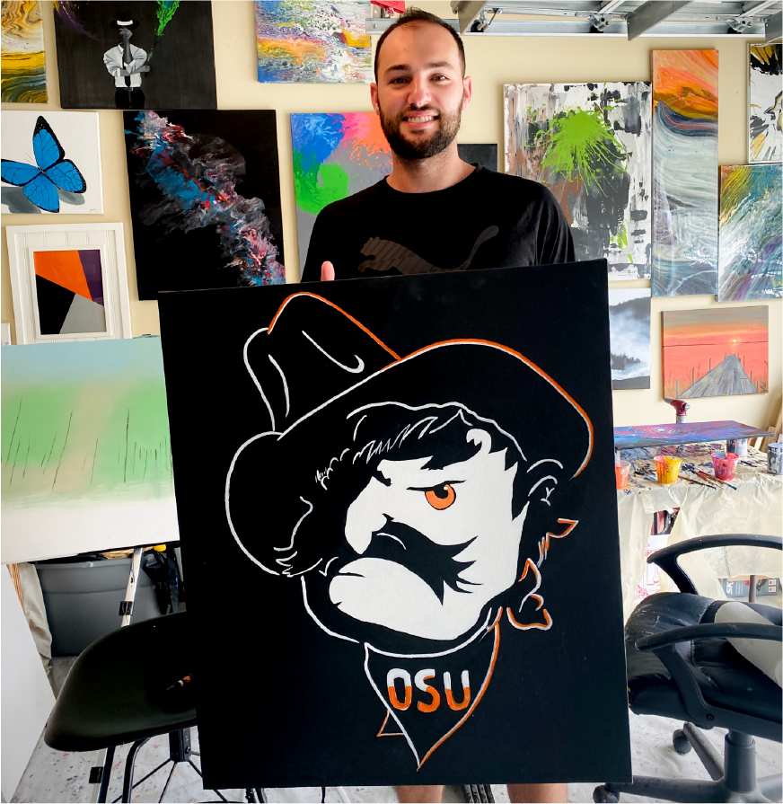 An artist holding his canvas at inside his studio