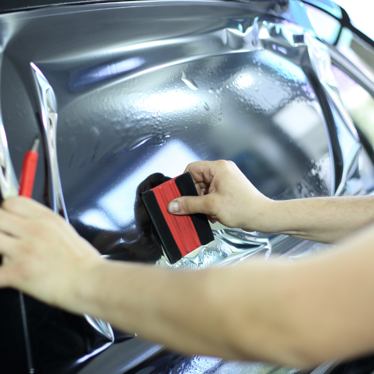 Tech installing an auto window tint