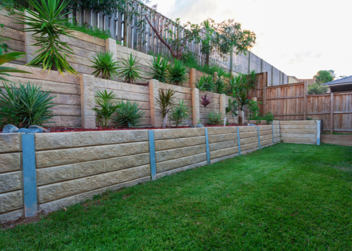 multilevel retaining wall with plants in backyard