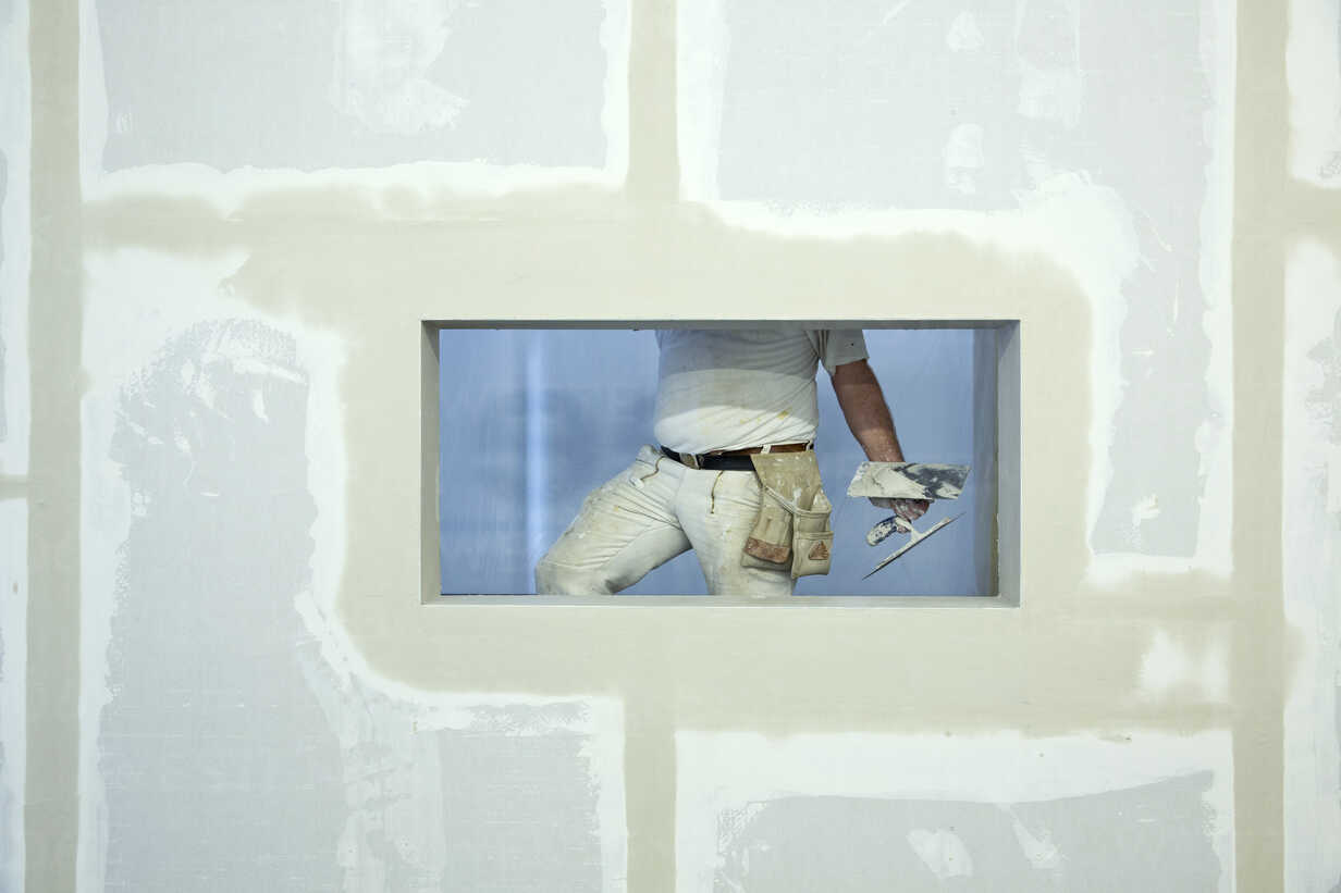 man doing drywall repairs