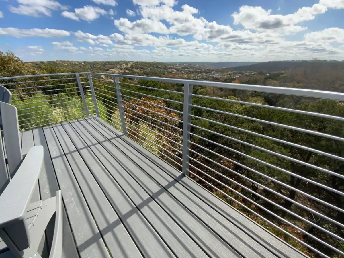 long gray railing with small wires running horizonal