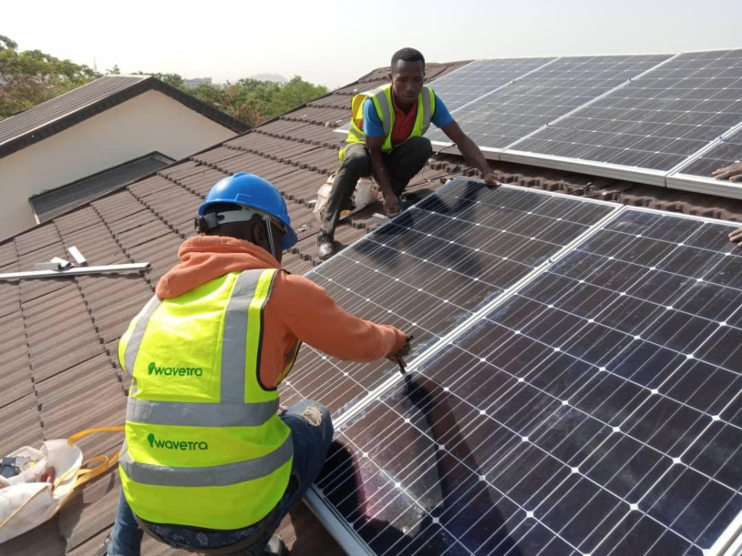 Techs installing a solar panel
