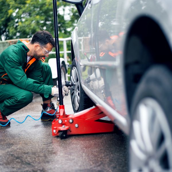 Worker inflating a flat tire